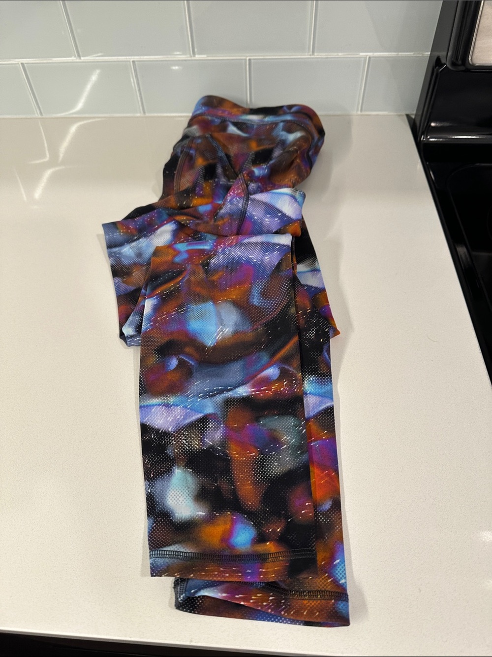 Abstract Multicolor Lululemon women’s leggings with side pockets.